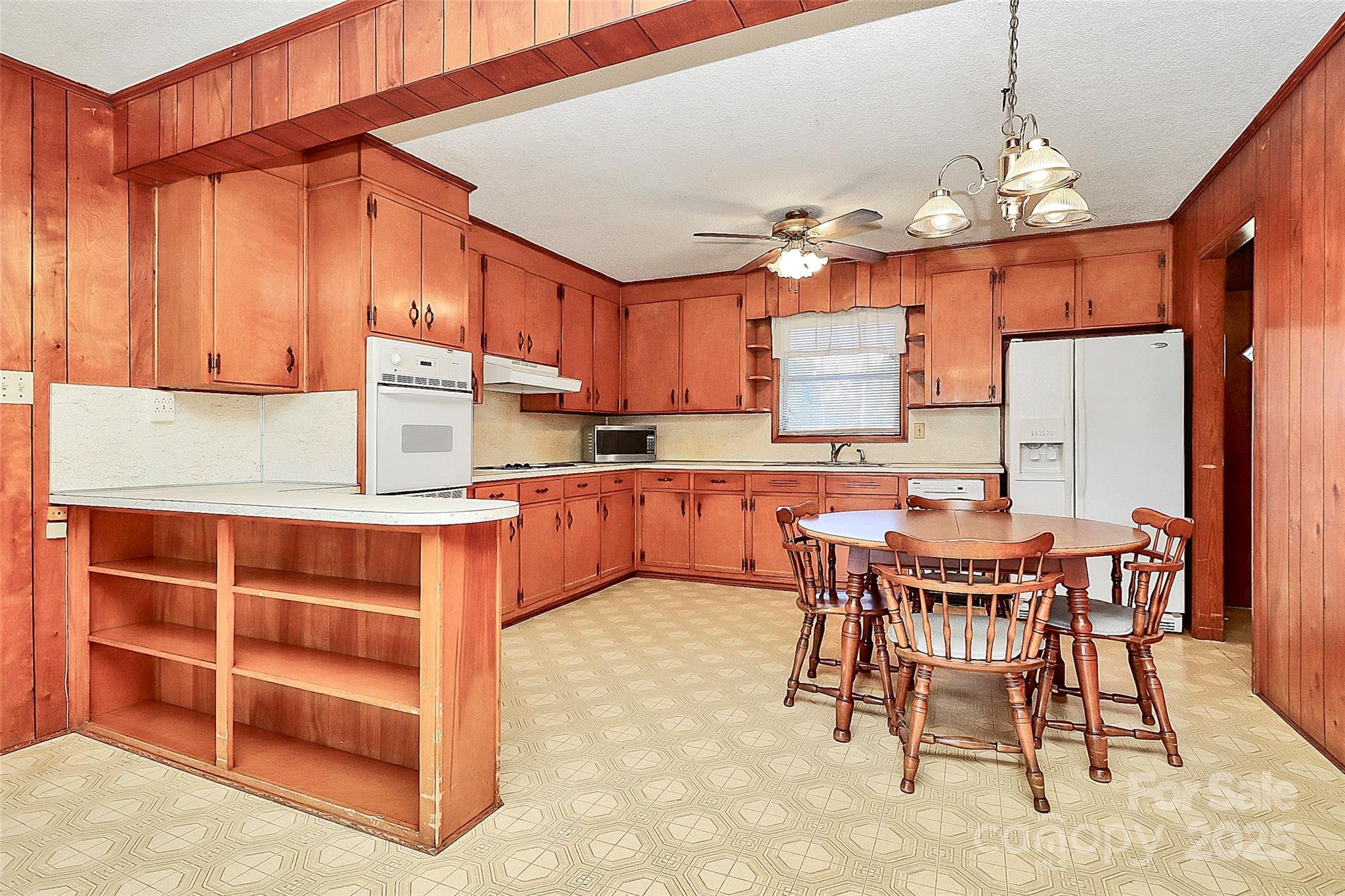 6217 Stack Road Monroe, NC 28112 - Photo 10 of 37 a kitchen with kitchen island granite countertop a sink cabinets and refrigerator