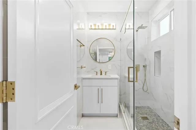 a bathroom with a granite countertop sink a toilet and a mirror