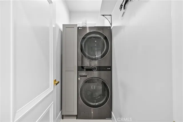 a living room with furniture a chandelier and a flat screen tv