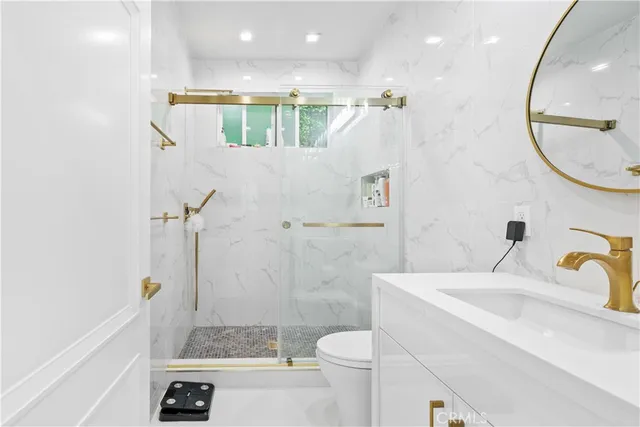 a bathroom with a sink a toilet and a mirror