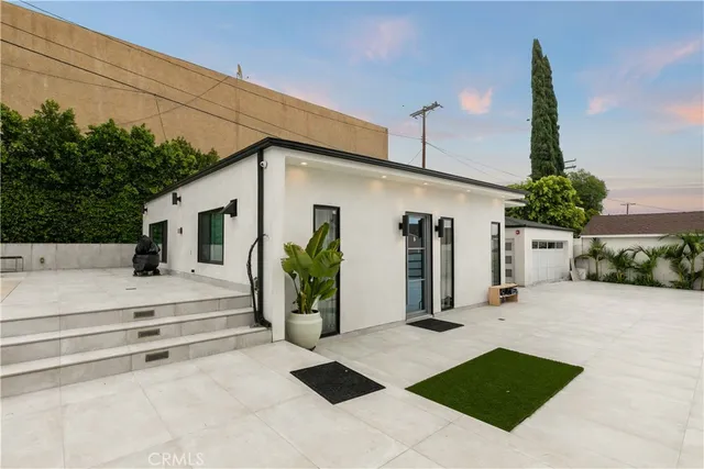 a view of a dining room with furniture and a chandelier
