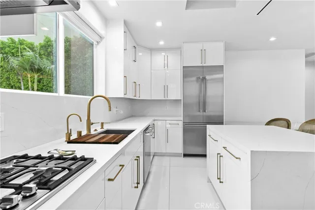 a living room with furniture a flat screen tv and kitchen view