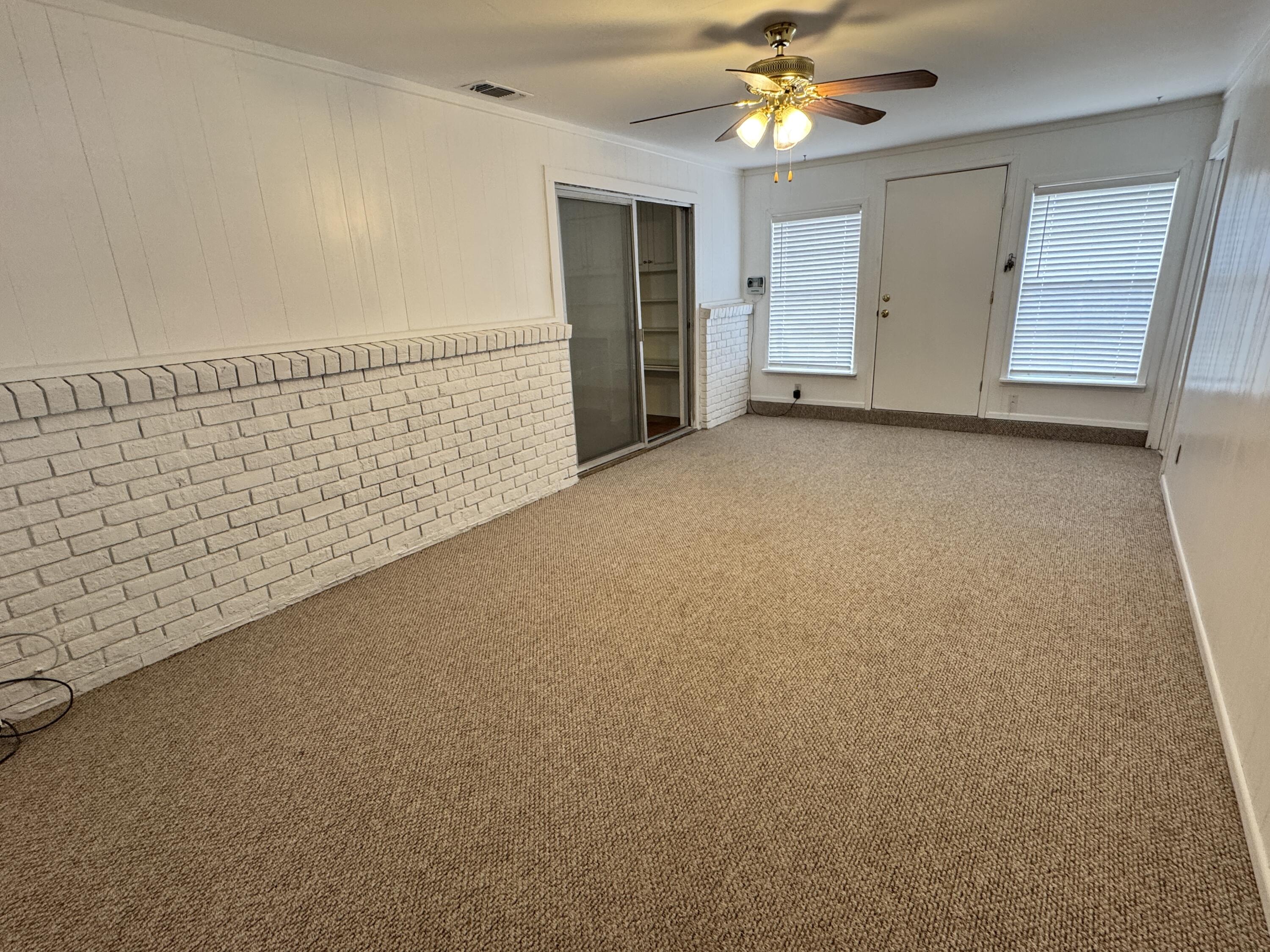 1209 Garland Plainview, TX 79072 - Photo 14 of 38 a view of a livingroom with a ceiling fan and window