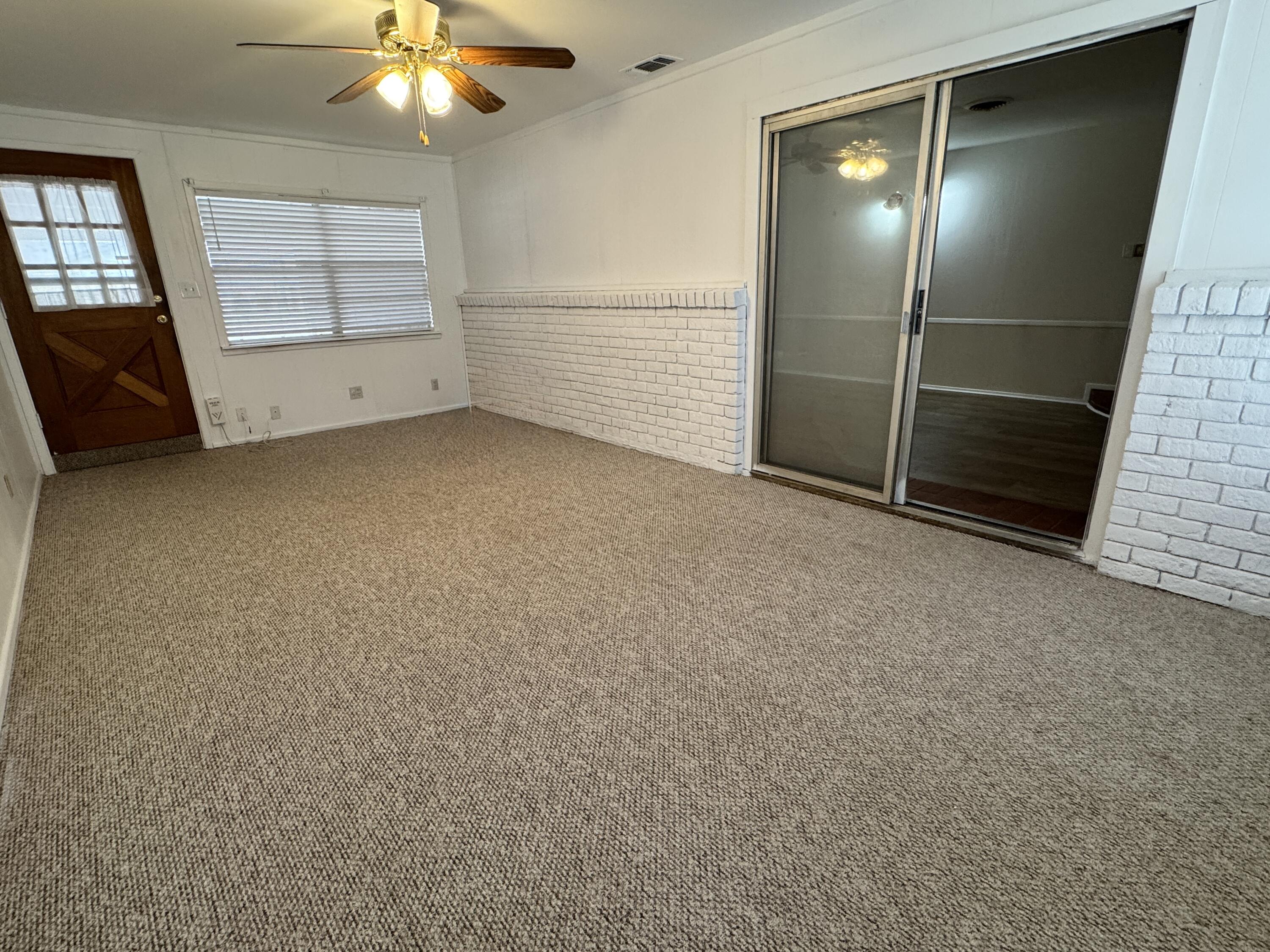 1209 Garland Plainview, TX 79072 - Photo 15 of 38 an empty room with windows and fireplace