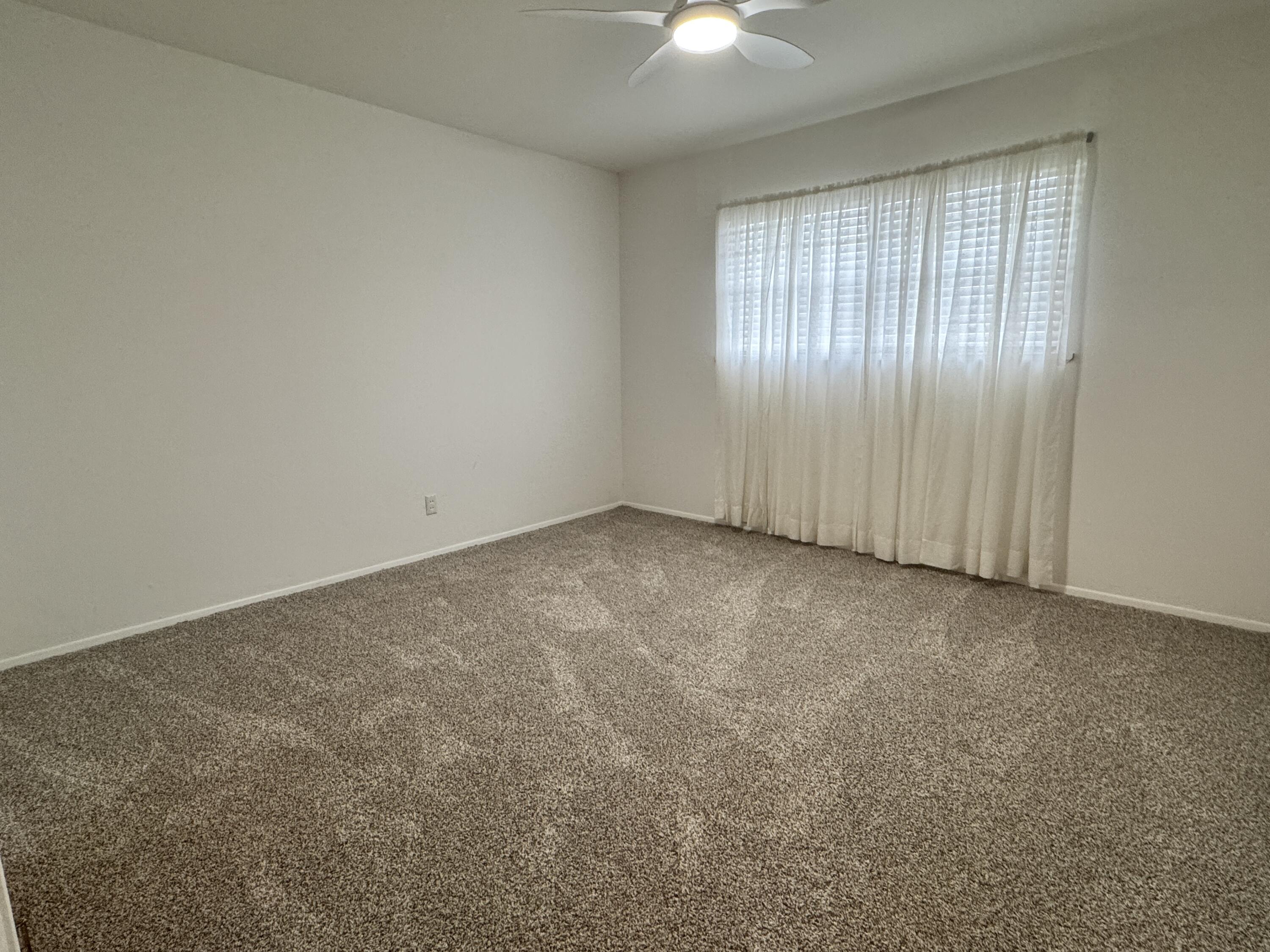 1209 Garland Plainview, TX 79072 - Photo 19 of 38 an empty room with chandelier fan