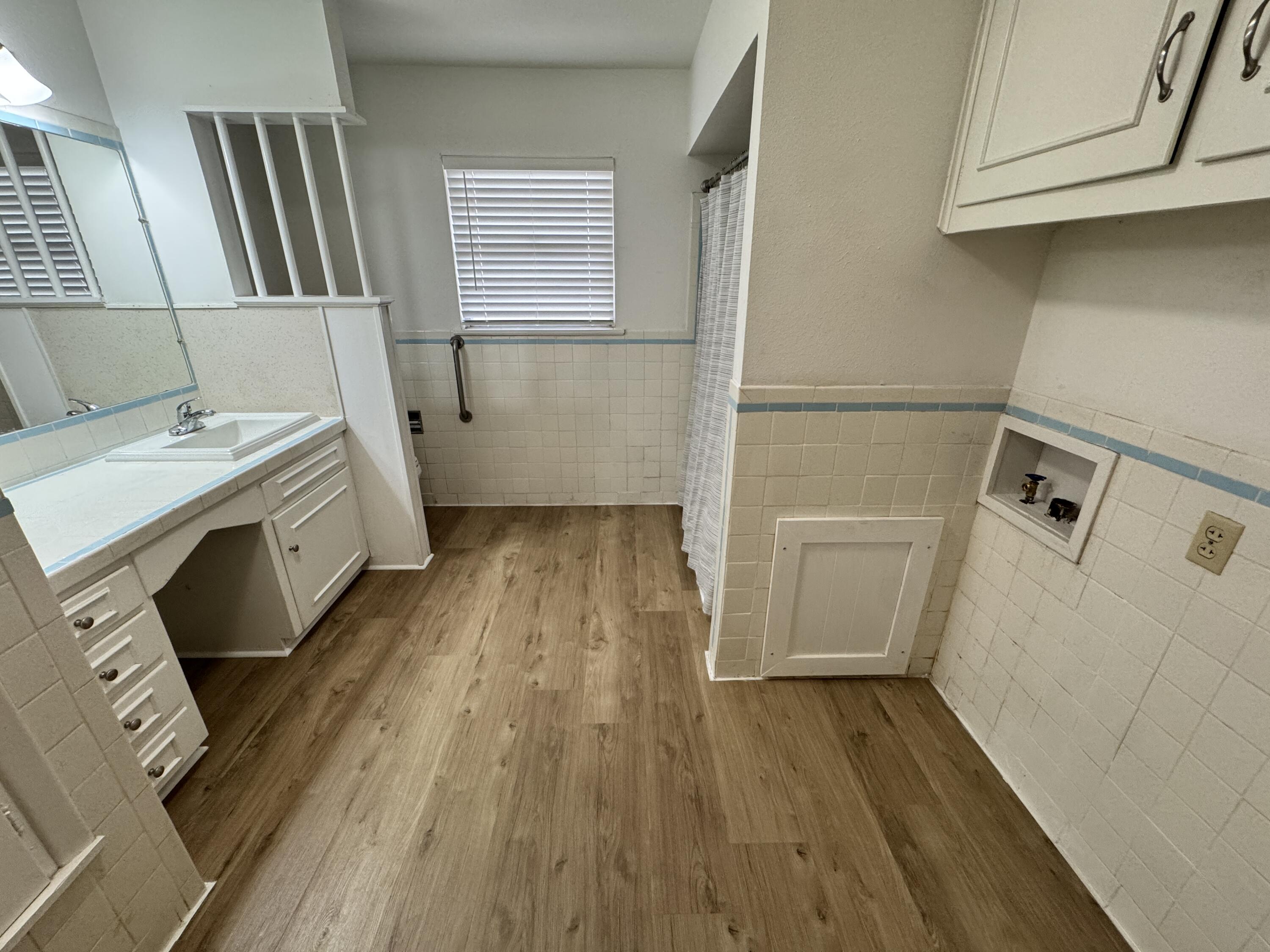 1209 Garland Plainview, TX 79072 - Photo 21 of 38 a view of a kitchen with wooden floor and electronic appliances