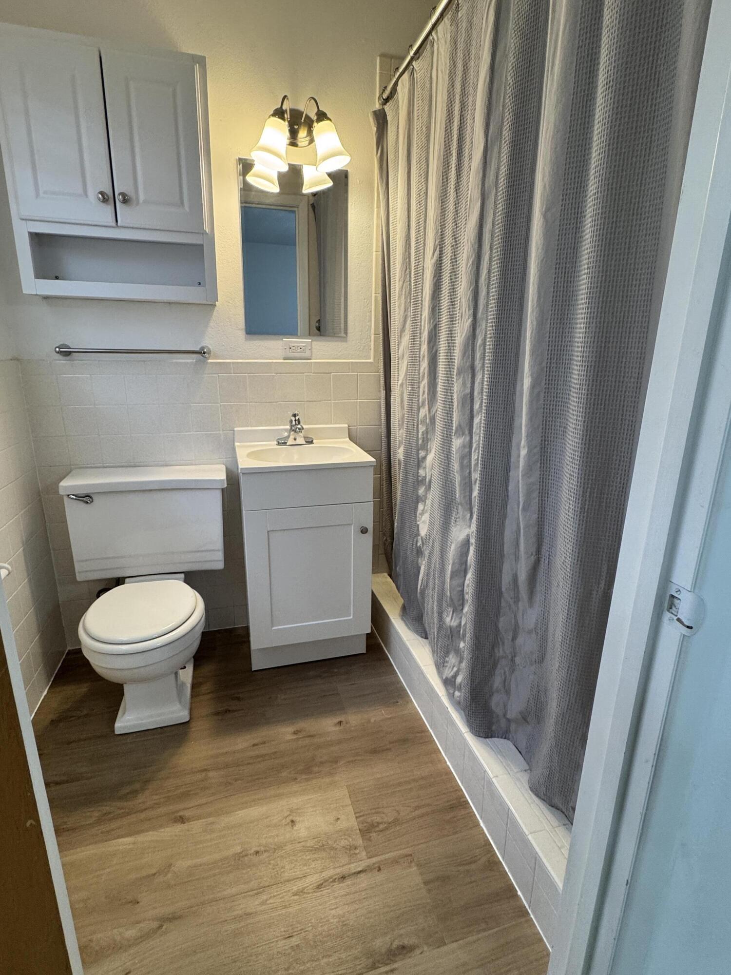 1209 Garland Plainview, TX 79072 - Photo 23 of 38 a bathroom with a toilet a sink and bathtub