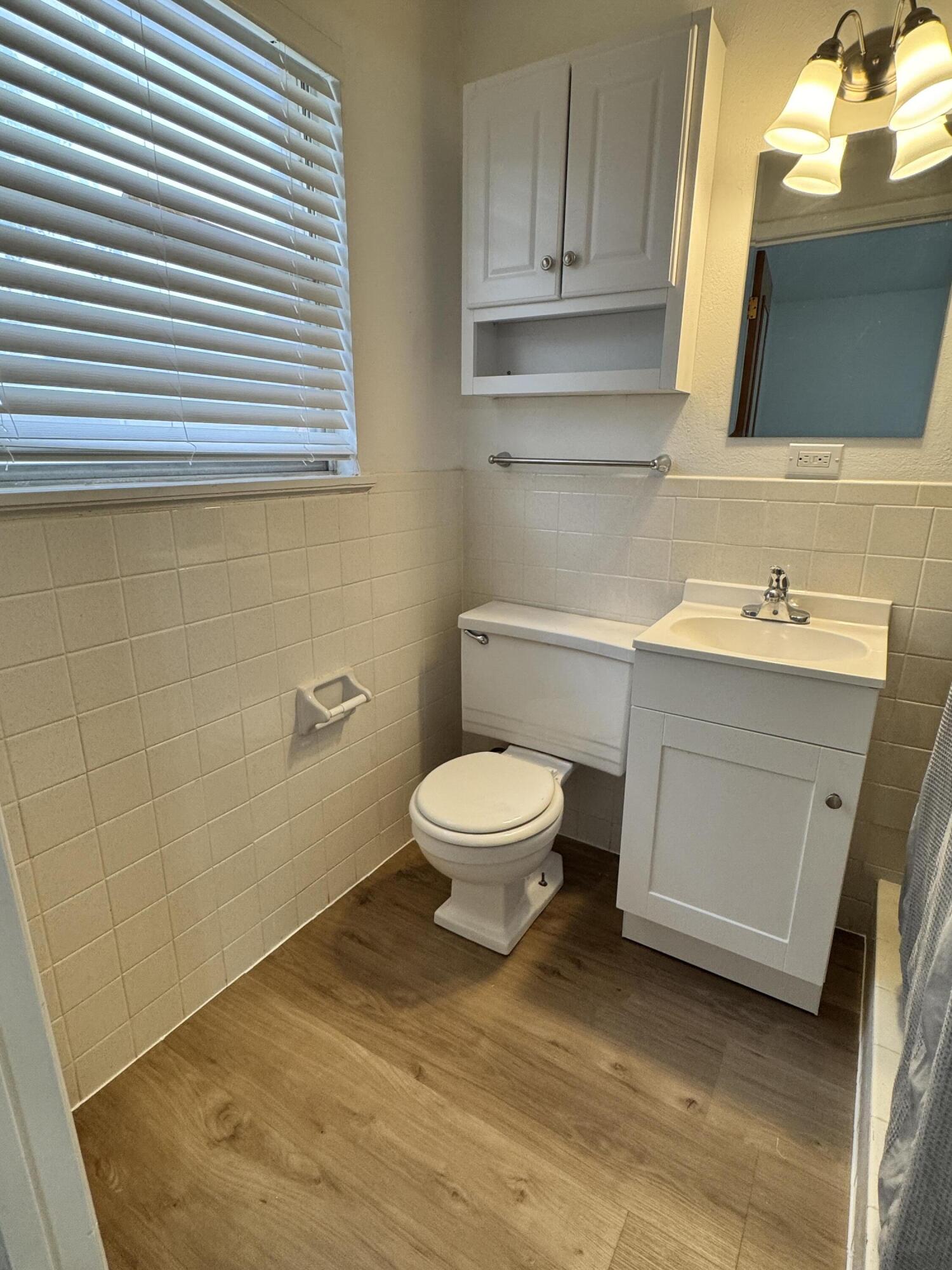 1209 Garland Plainview, TX 79072 - Photo 24 of 38 a bathroom with a toilet a sink and mirror