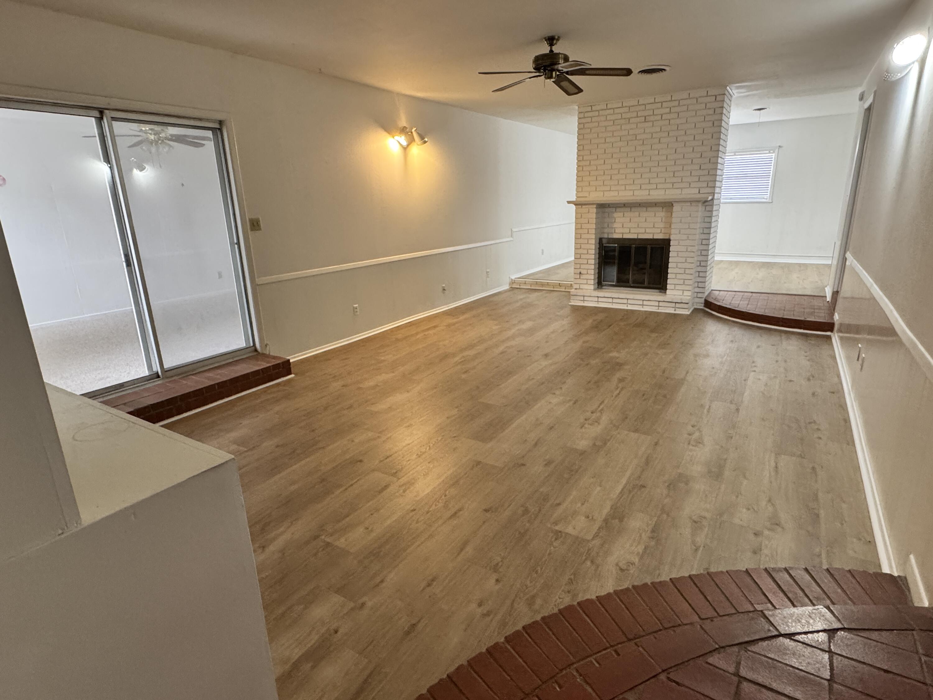 1209 Garland Plainview, TX 79072 - Photo 7 of 38 a view of empty room with wooden floor and fan