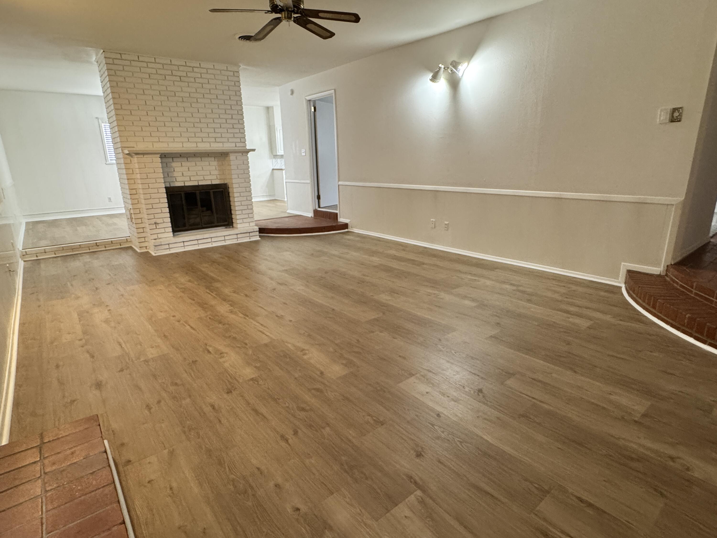 1209 Garland Plainview, TX 79072 - Photo 8 of 38 a view of an empty room with a fireplace and a window