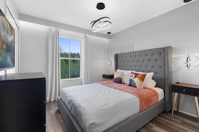 a bedroom with a large bed and a window