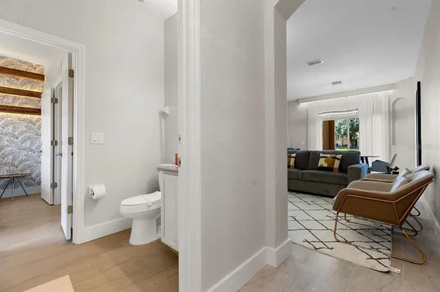 a living room with furniture and a potted plant