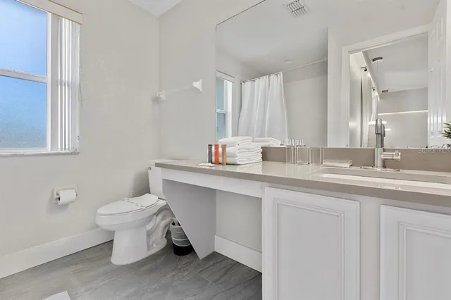 a bathroom with a sink toilet and a mirror