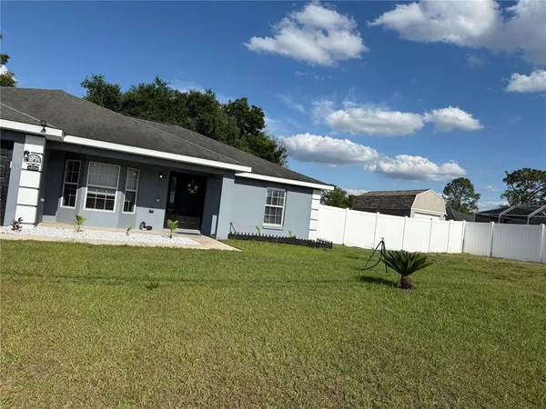 a view of a house with backyard and porch