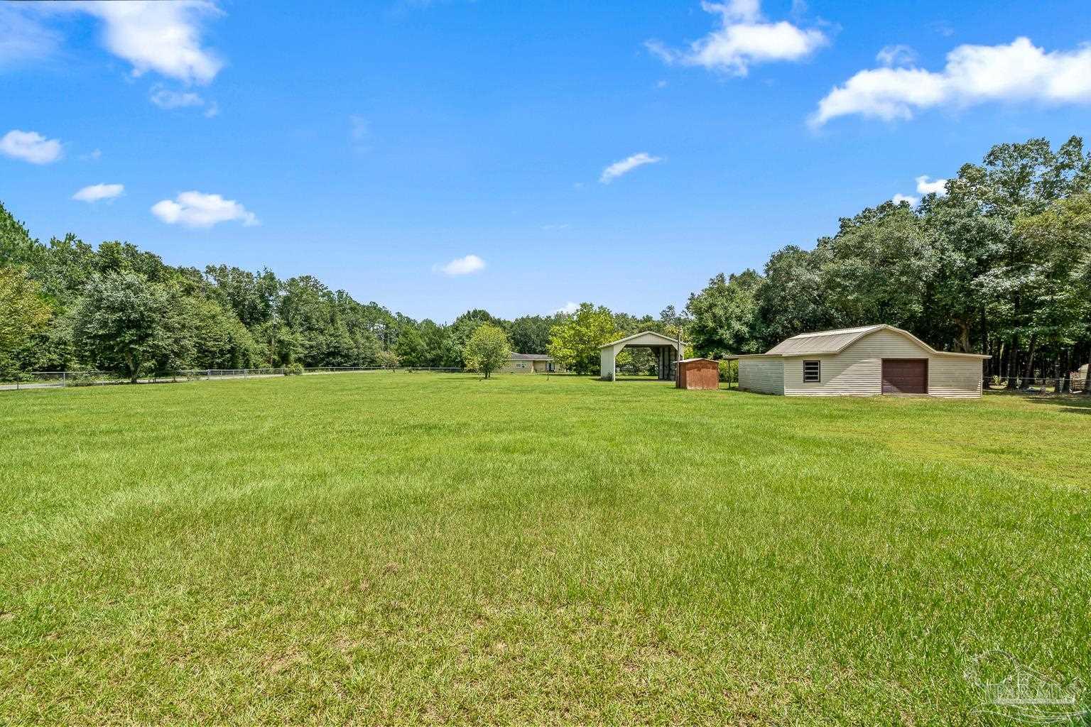 6160 Saddle Club Road Pace, FL 32571 - Photo 11 of 49 a front view of a house with garden