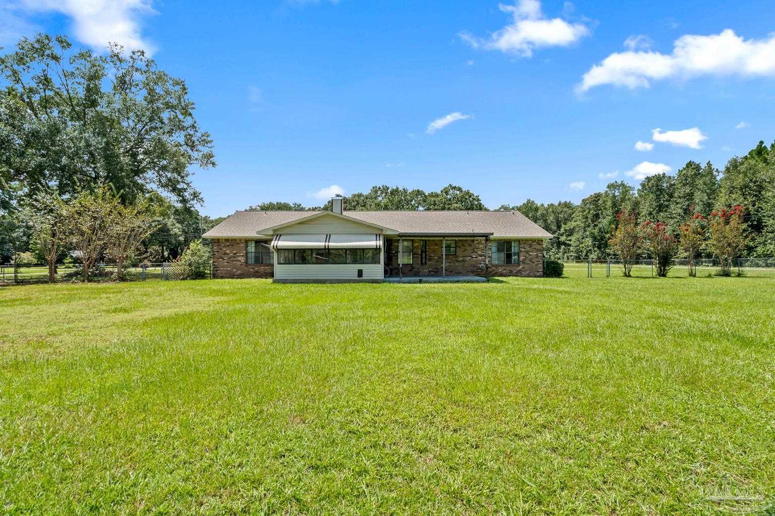 6160 Saddle Club Road Pace, FL 32571 - Photo 12 of 49 a front view of house with yard and green space