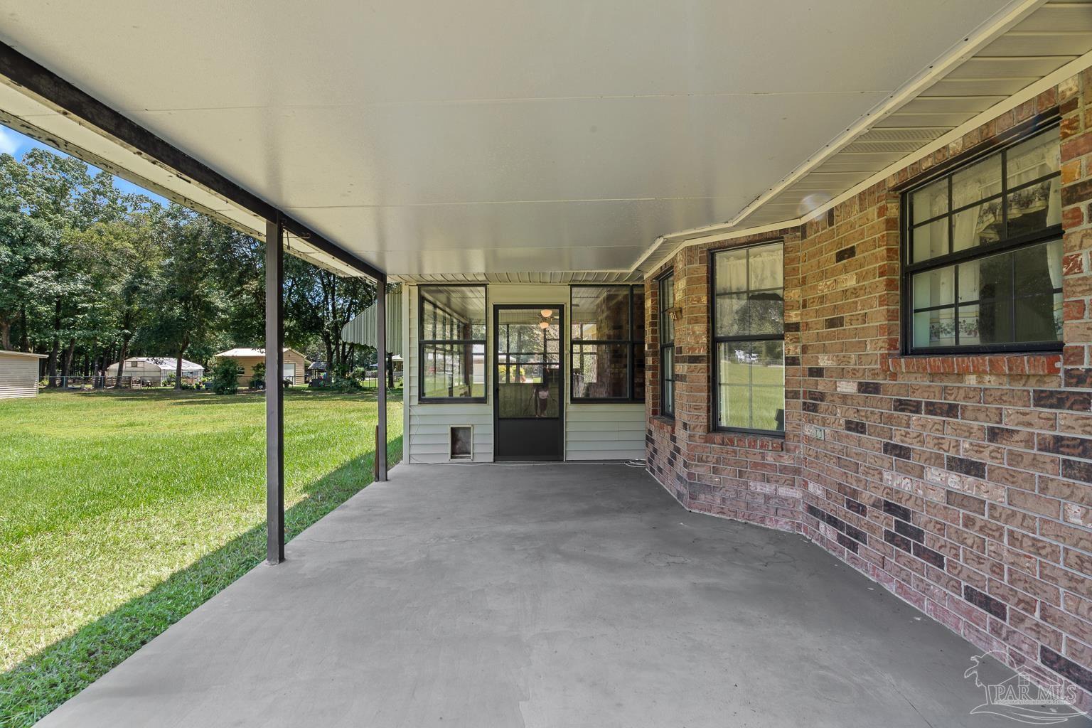 6160 Saddle Club Road Pace, FL 32571 - Photo 13 of 49 a view of a house with backyard and porch