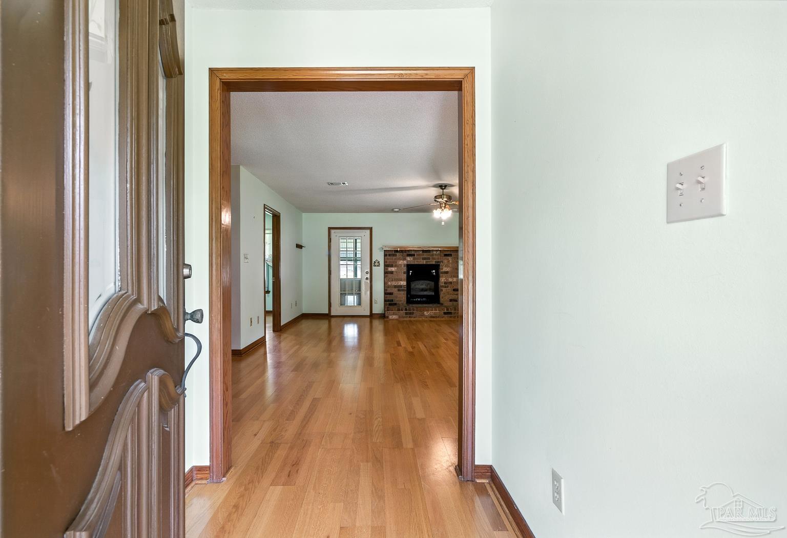 6160 Saddle Club Road Pace, FL 32571 - Photo 14 of 49 a view of a hallway view with wooden floor and staircase