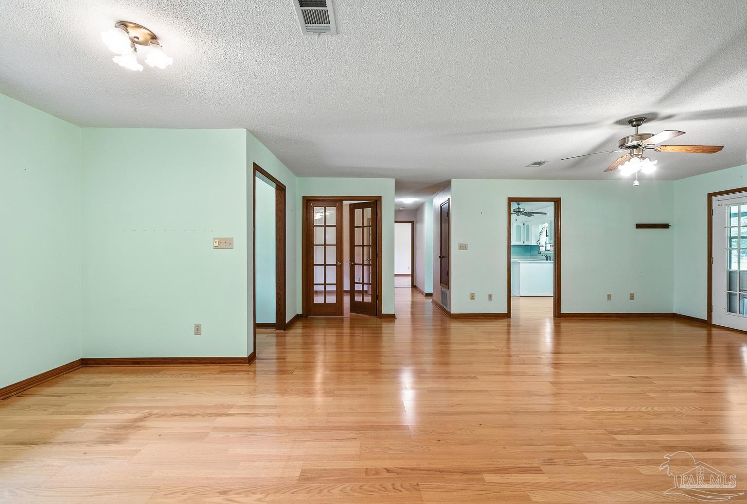 6160 Saddle Club Road Pace, FL 32571 - Photo 17 of 49 a view of an empty room with window and a kitchen