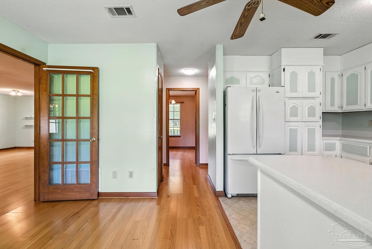 6160 Saddle Club Road Pace, FL 32571 - Photo 27 of 49 a view of a kitchen with wooden floor and windows