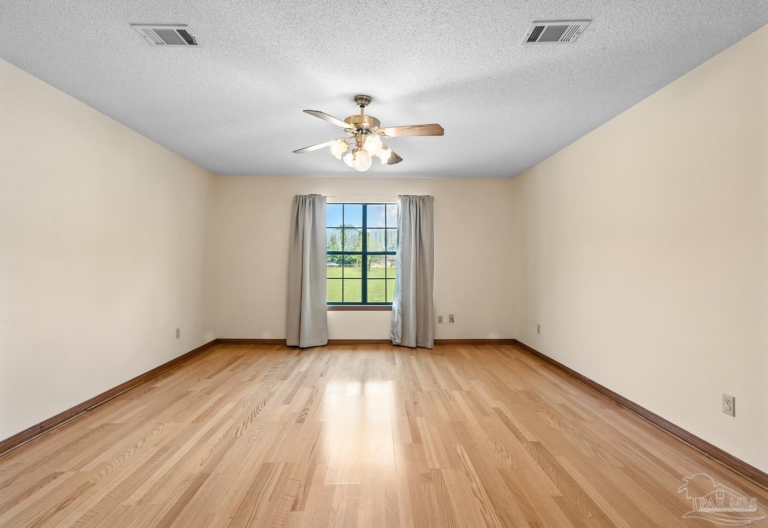 6160 Saddle Club Road Pace, FL 32571 - Photo 29 of 49 wooden floor in an empty room with a window