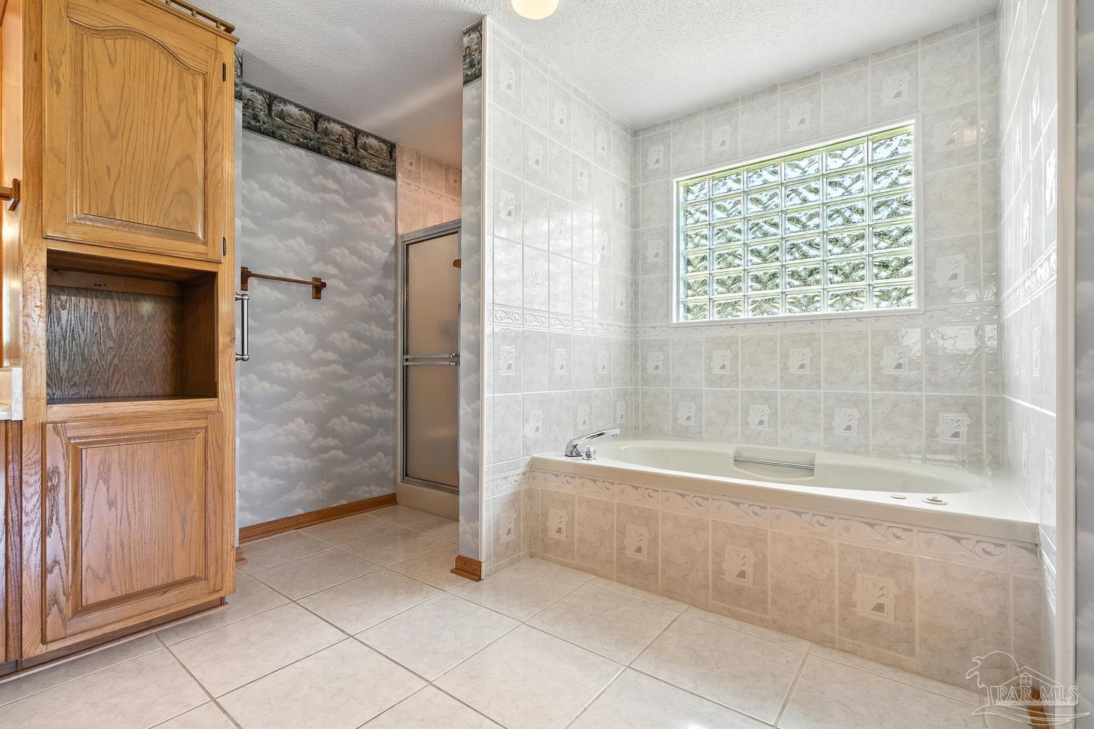 6160 Saddle Club Road Pace, FL 32571 - Photo 32 of 49 a spacious bathroom with a bathtub and a shower