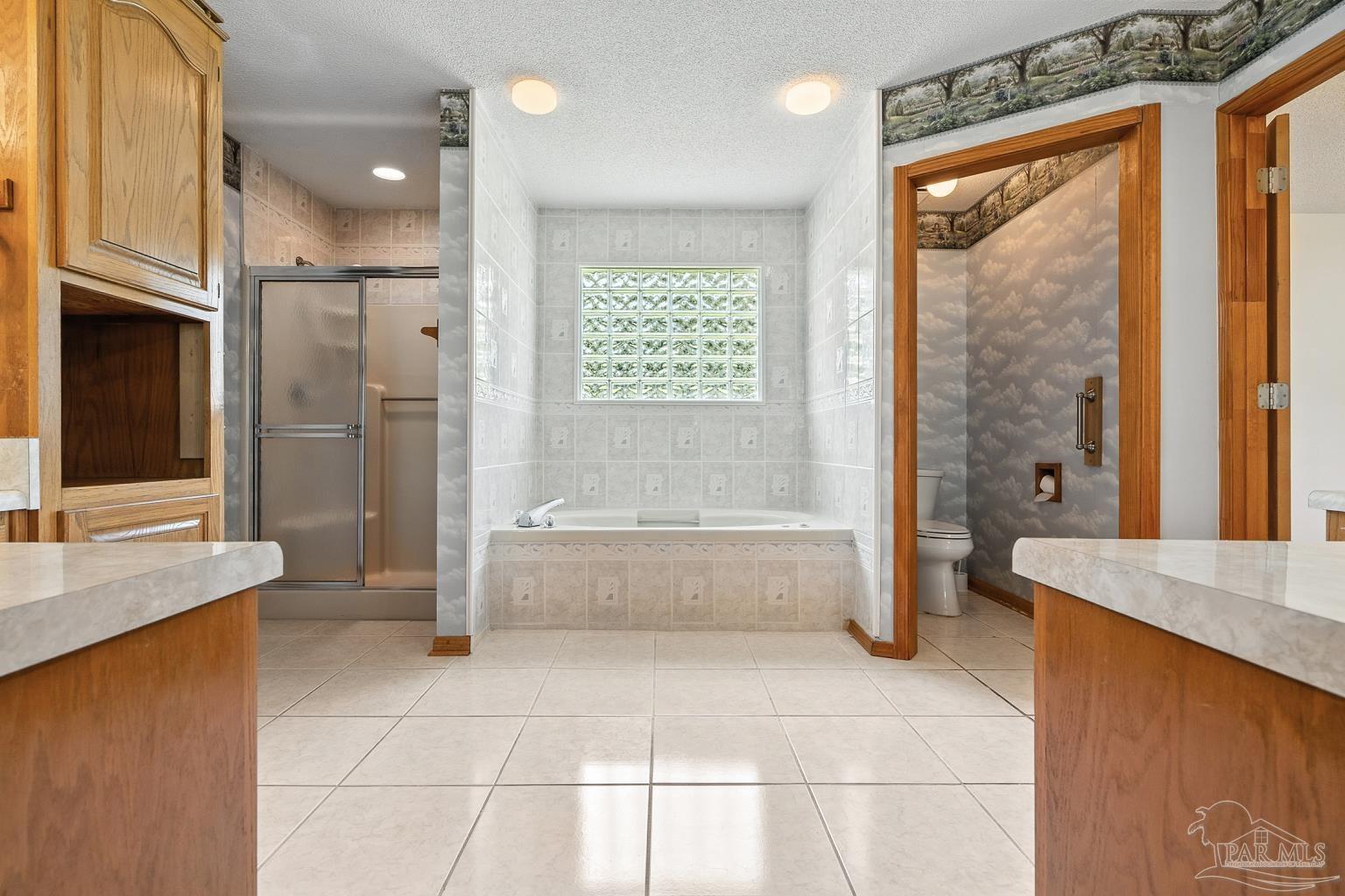 6160 Saddle Club Road Pace, FL 32571 - Photo 33 of 49 a bathroom with a granite countertop sink a toilet and shower