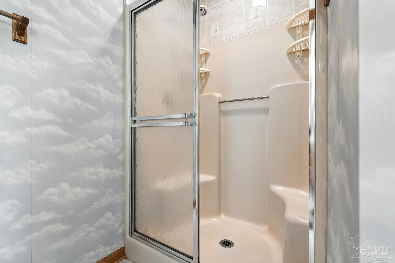 6160 Saddle Club Road Pace, FL 32571 - Photo 34 of 49 a bathroom with a glass shower door