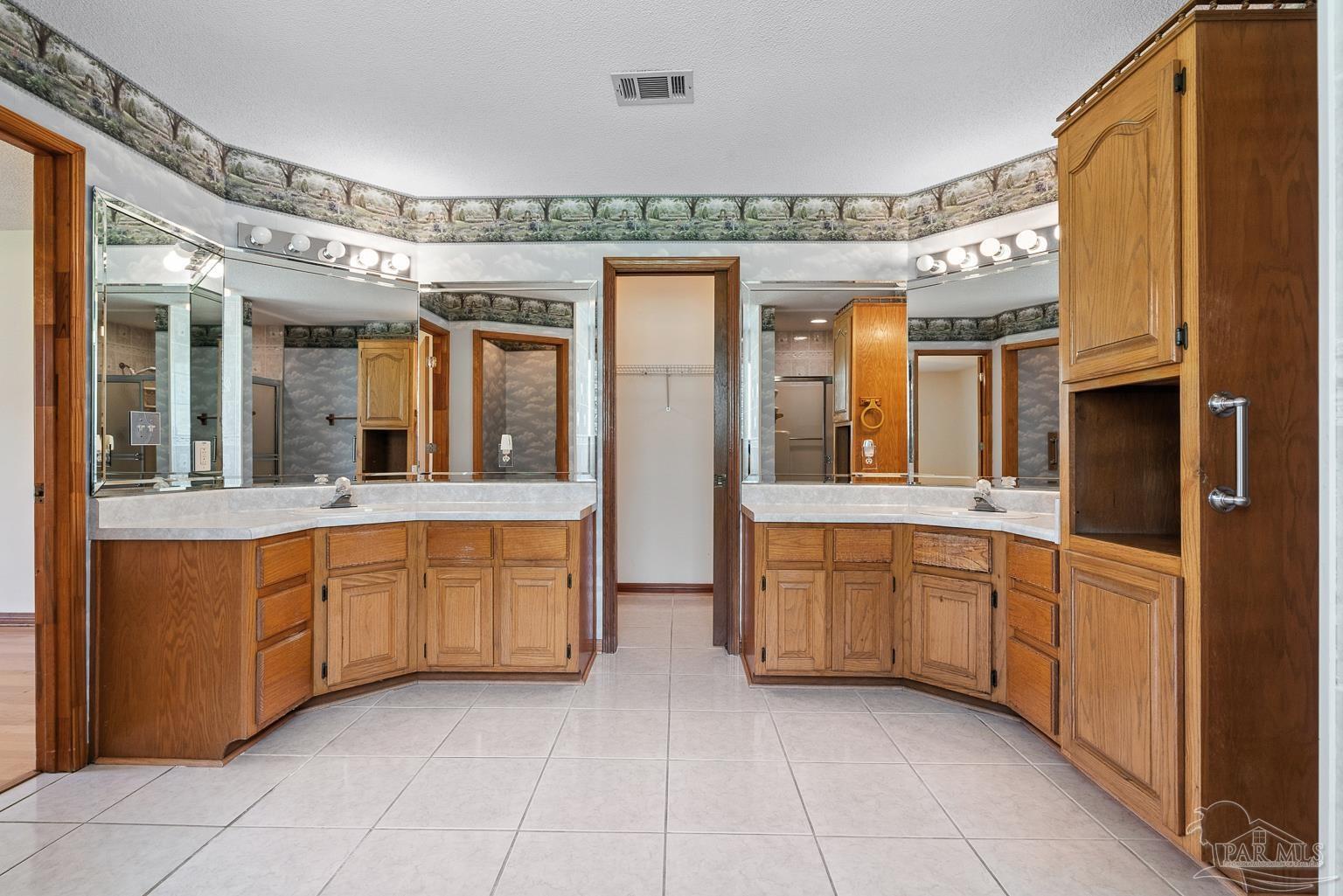 6160 Saddle Club Road Pace, FL 32571 - Photo 36 of 49 a spacious bathroom with a granite countertop sink mirror and bathtub