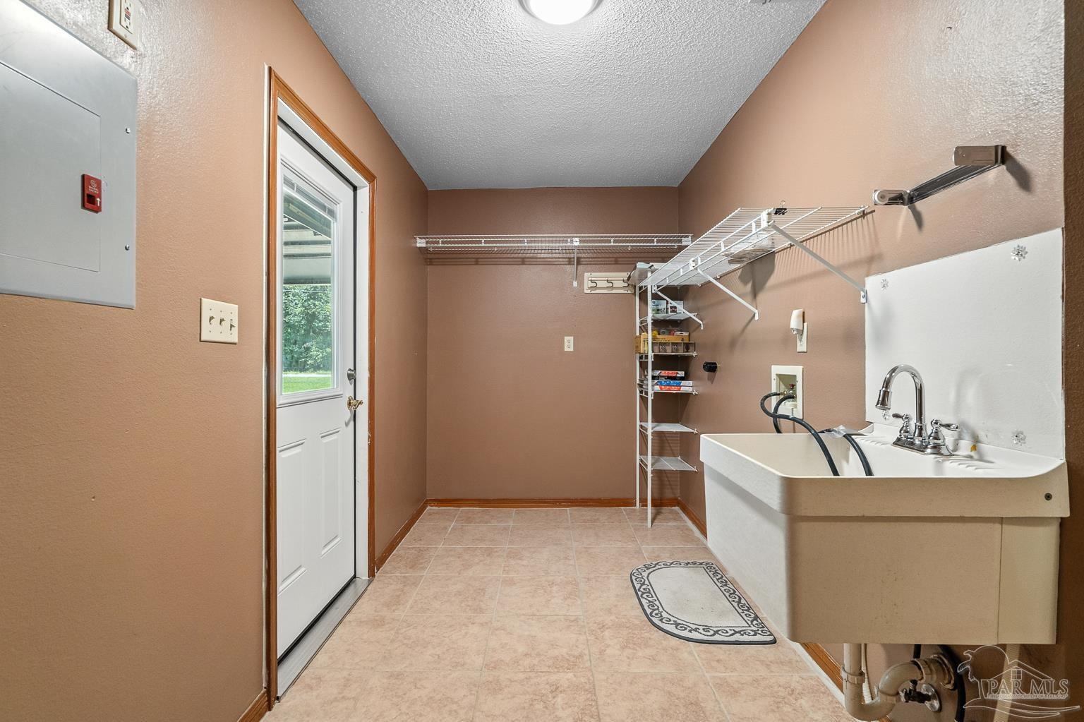 6160 Saddle Club Road Pace, FL 32571 - Photo 43 of 49 a room with furniture a flat screen tv and a window