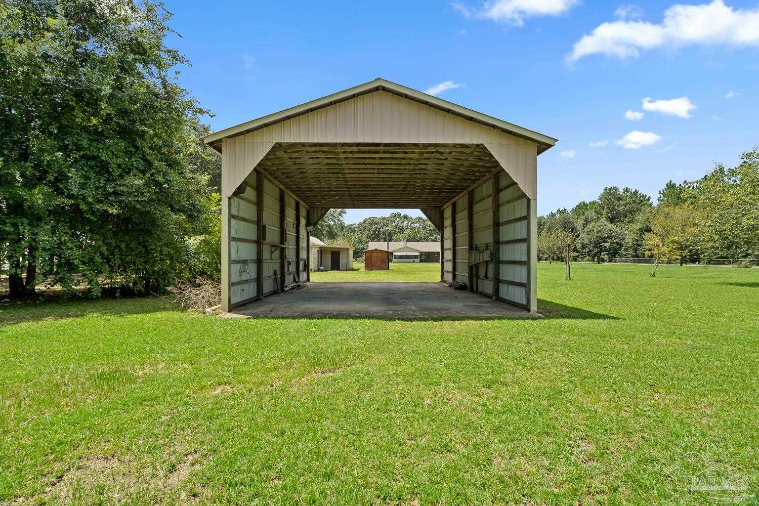 6160 Saddle Club Road Pace, FL 32571 - Photo 9 of 49 a front view of a house with garden
