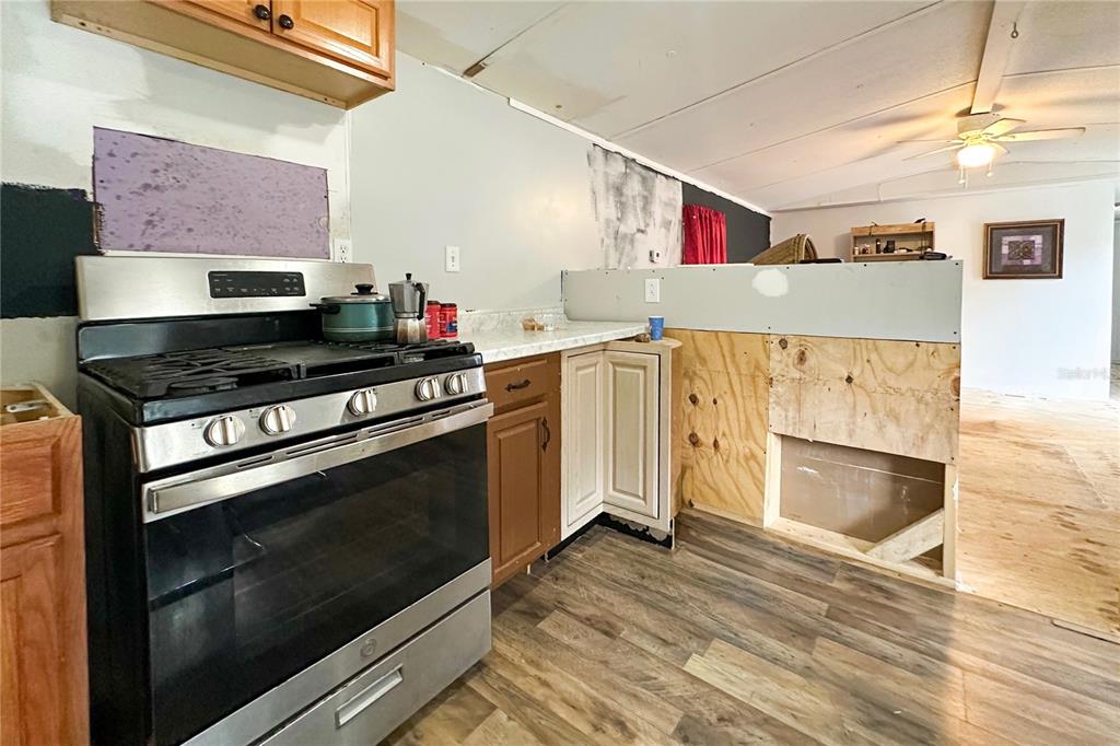 198 Spurlock Road Frostproof, FL 33843 - Photo 20 of 50 a kitchen with stainless steel appliances and white cabinets