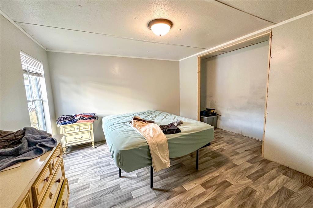 198 Spurlock Road Frostproof, FL 33843 - Photo 24 of 50 a living room with furniture and a wooden floor