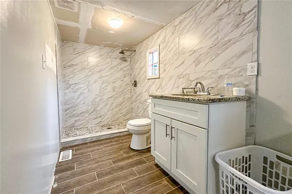 a bedroom with a bed and a dresser