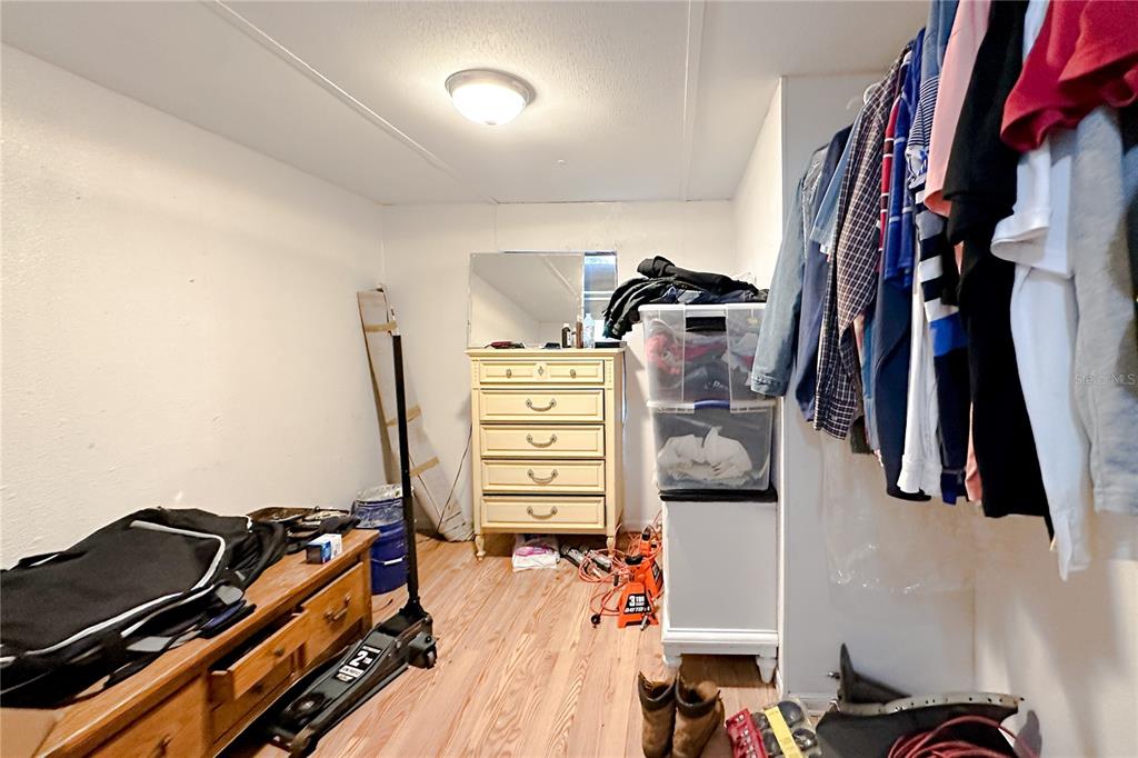 198 Spurlock Road Frostproof, FL 33843 - Photo 31 of 50 a view of walk in closet with clothes and shoes