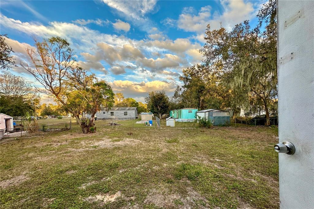 198 Spurlock Road Frostproof, FL 33843 - Photo 32 of 50 a view of a yard with a house in the background