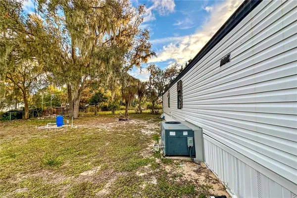a backyard of house with large trees