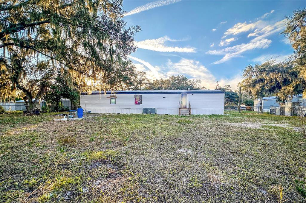 198 Spurlock Road Frostproof, FL 33843 - Photo 42 of 50 a view of a backyard with large trees