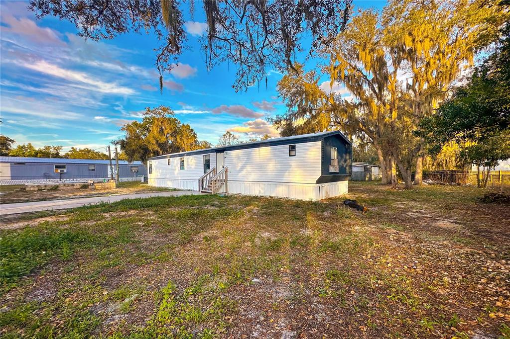 198 Spurlock Road Frostproof, FL 33843 - Photo 6 of 50 a view of a street with a building in the background