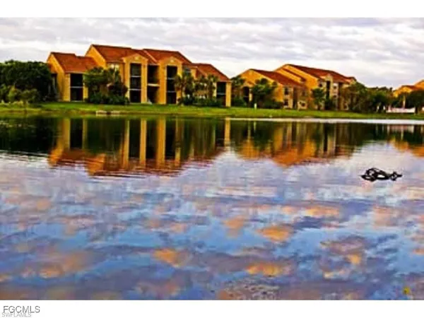 a view of a lake with a house in the background