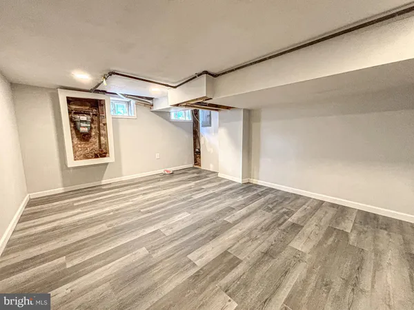 a view of a bedroom with wooden floor