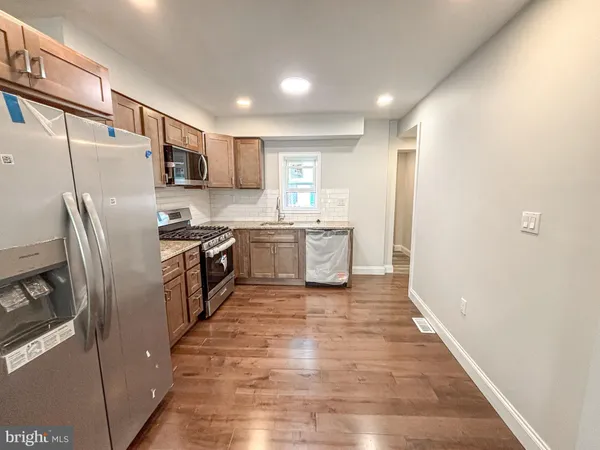 a kitchen with stainless steel appliances a refrigerator and a stove