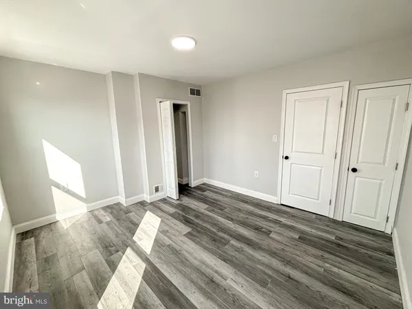 a view of an empty room and wooden floor