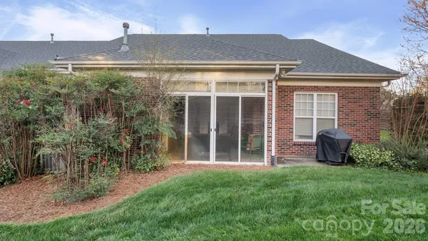 a front view of a house with yard and green space
