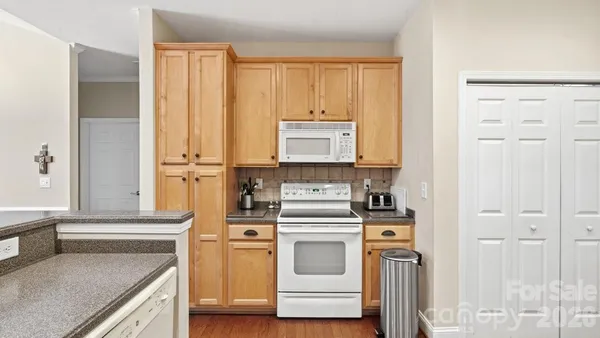 a kitchen with stainless steel appliances white cabinets and a refrigerator