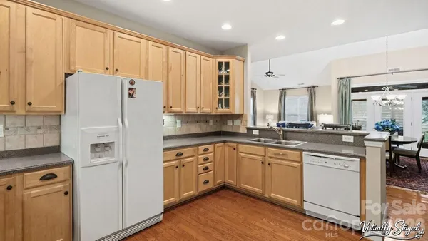 a kitchen with stainless steel appliances granite countertop a refrigerator sink and cabinets