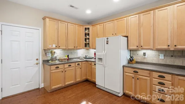 a view of washer and dryer with kitchen in the background