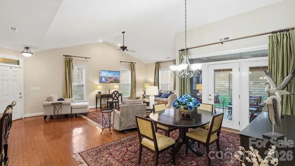 a view of a dining room with furniture and a chandelier