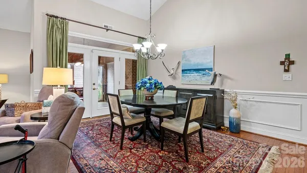 a living room with furniture and a chandelier