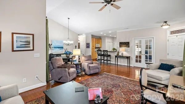 a bedroom with a bed and dresser with mirror